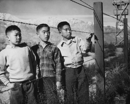 Toyo Miyatake, Boys Behind Barbed Wire (Norito Takamoto, Albert Masaichi, and Hisashi Sansui), 1944. Gelatin silver print. Courtesy of Alan Miyatake, Toyo Miyatake Manzanar Collection.
