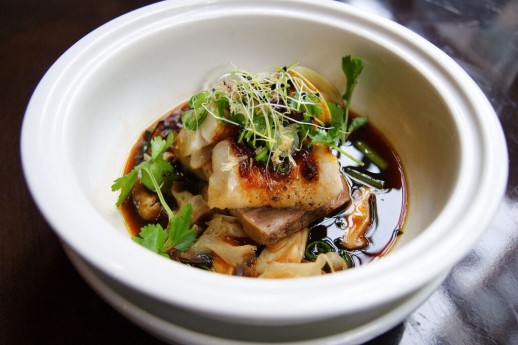 Steamed Black Cod with fermented flavors, bitter greens, pork belly, shiitake, and leeks.